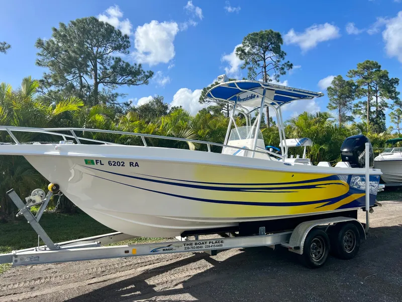 Slide: The Image of 2016 Renegade 250 boat on trailer with yellow and blue accents. - 4