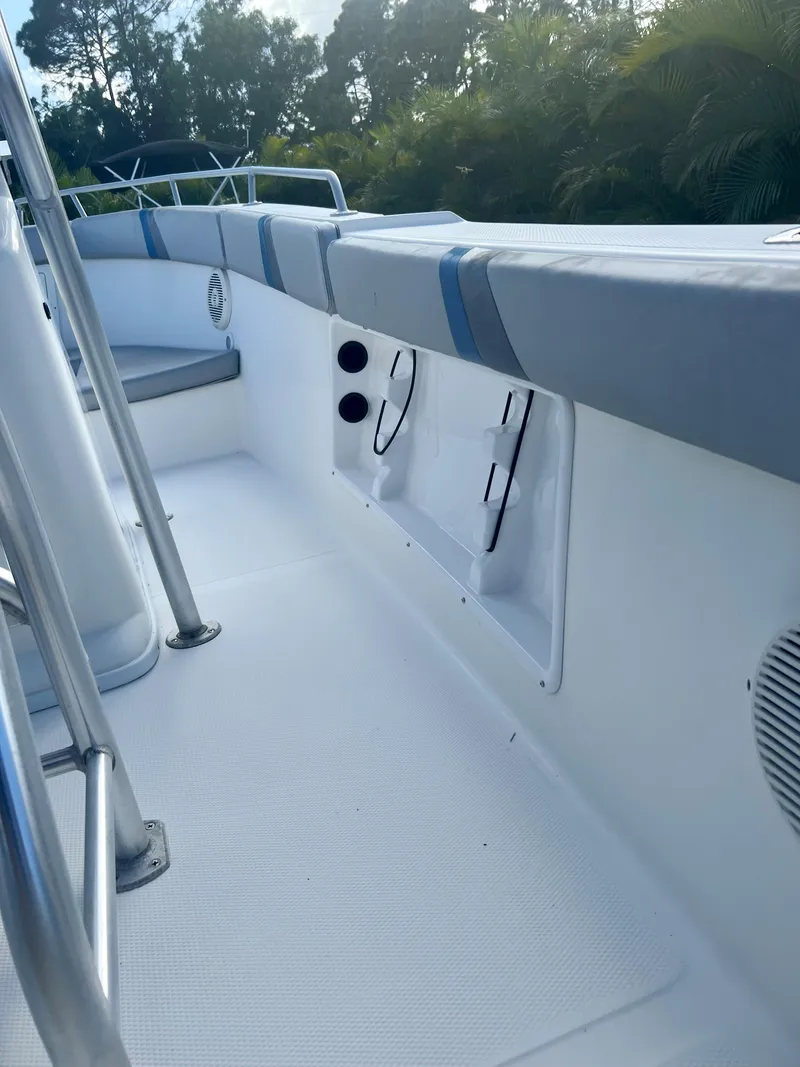 Slide: The Image of 2016 Renegade 250 boat interior with cushioned seating and storage compartments. - 9