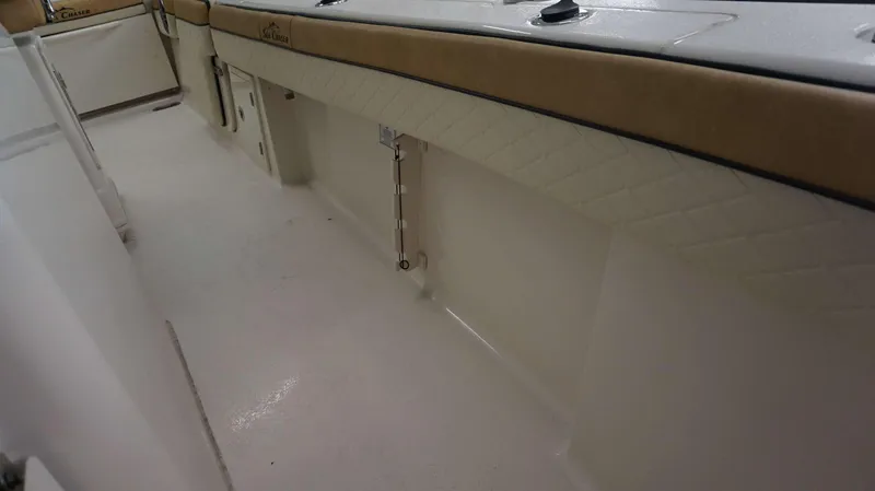 Slide: The Image of Interior view of 2023 Sea Chaser 27 HFC boat with cushioned seating and storage compartments. - 11