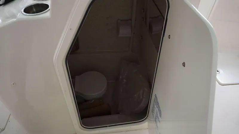 Slide: The Image of Interior view of the 2023 Sea Chaser 27 HFC boat's compact bathroom. - 14