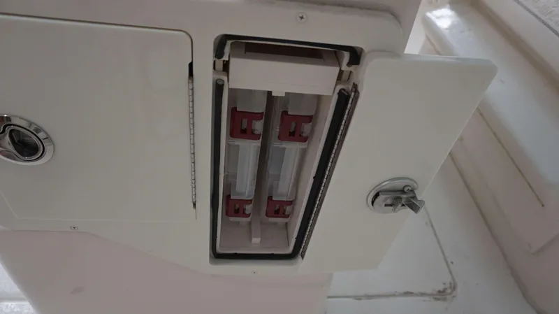 Slide: The Image of 2023 Sea Chaser 27 HFC boat compartment with open storage and locking mechanism. - 17