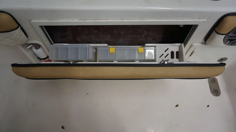 Slide: The Image of 2023 Sea Chaser 27 HFC storage compartment with tackle boxes and fire extinguisher. - 19