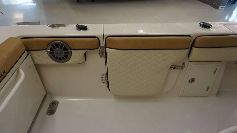 Slide: The Image of Interior of 2023 Sea Chaser 27 HFC boat with cushioned seating and speaker. - 21