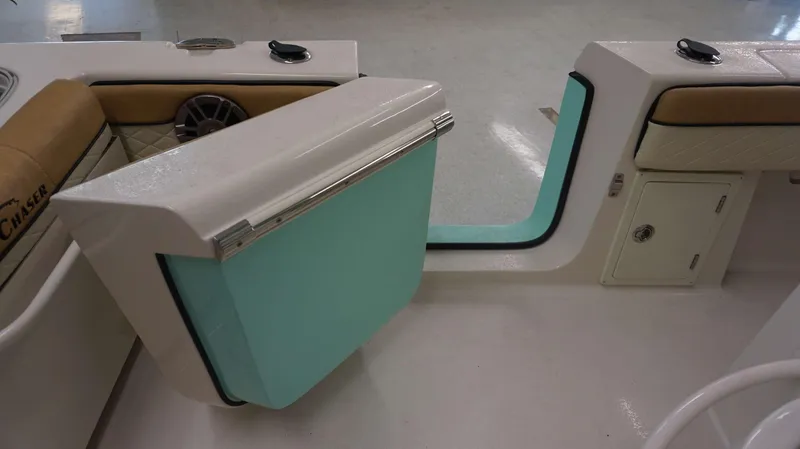 Slide: The Image of Interior view of 2023 Sea Chaser 27 HFC boat with teal door and tan seating. - 22