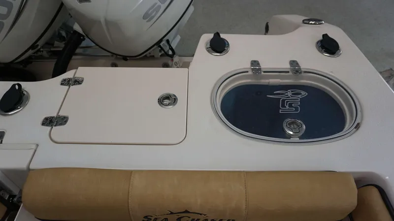 Slide: The Image of 2023 Sea Chaser 27 HFC boat console with storage compartments and livewell. - 23