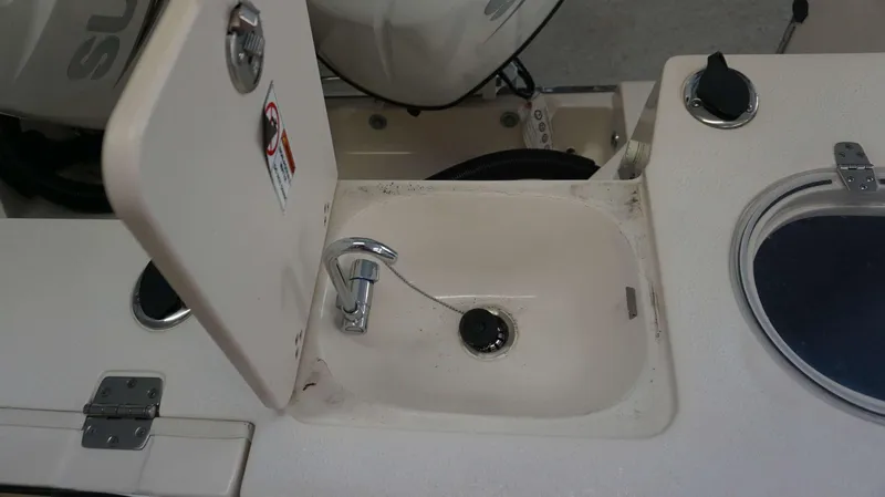 Slide: The Image of 2023 Sea Chaser 27 HFC boat sink and storage compartment. - 25