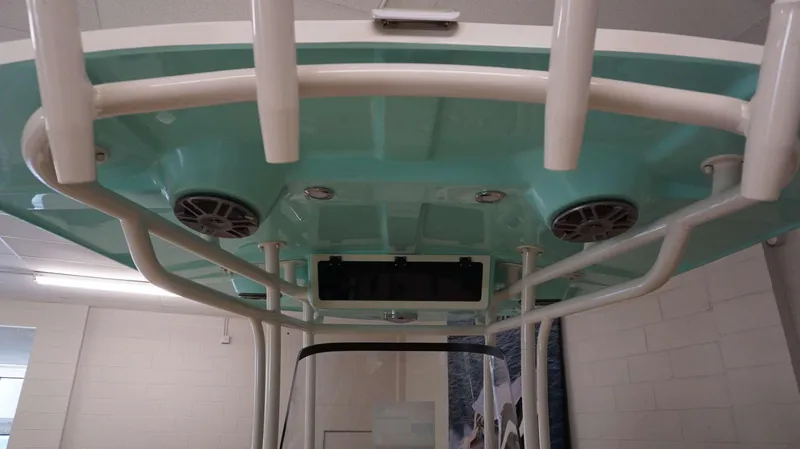 Slide: The Image of 2023 Sea Chaser 27 HFC boat T-top with speakers and rod holders. - 27