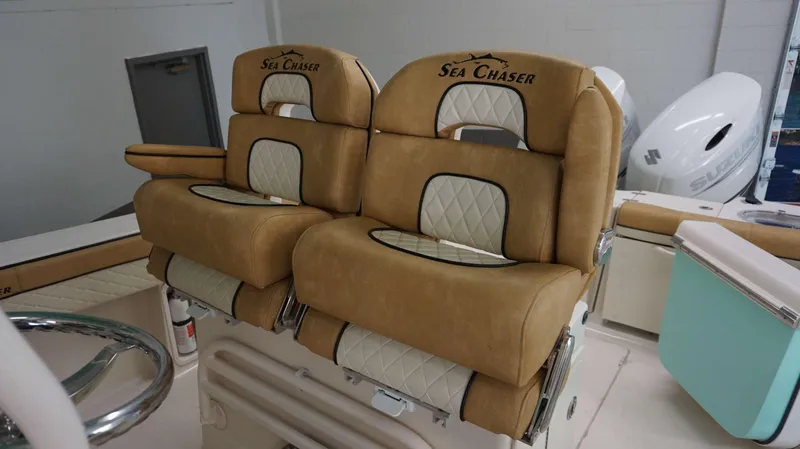 Slide: The Image of 2023 Sea Chaser 27 HFC boat seats with tan and white upholstery. - 31