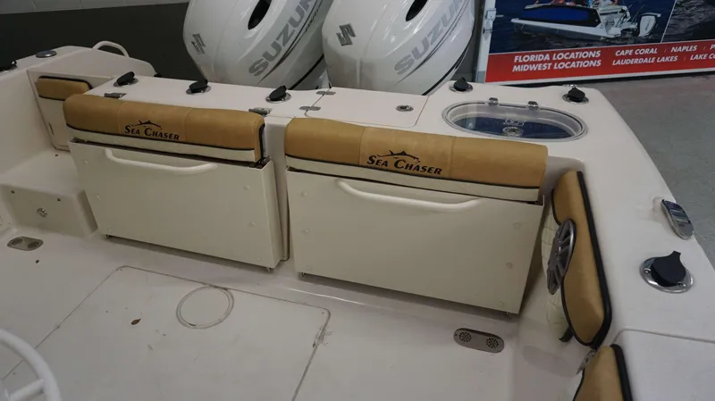 Slide: The Image of 2023 Sea Chaser 27 HFC boat interior with Suzuki engines and tan seating. - 32