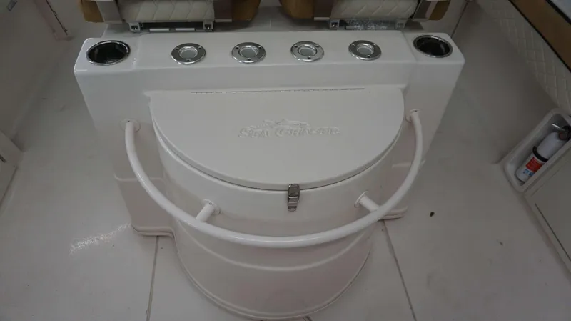 Slide: The Image of 2023 Sea Chaser 27 HFC boat interior with rod holders and storage compartment. - 33