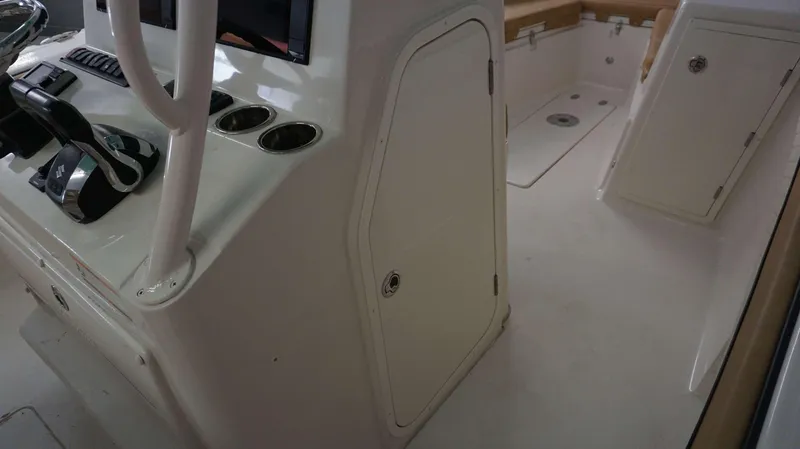 Slide: The Image of Interior of 2023 Sea Chaser 27 HFC boat, featuring control panel and storage compartments. - 6