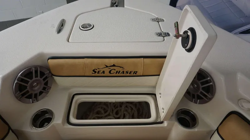 Slide: The Image of 2023 Sea Chaser 27 HFC boat storage compartment with speakers and rope. - 9
