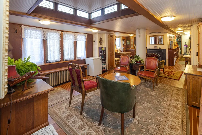 The Image of Cozy 1943 Custom Navy Tug interior with vintage furniture and warm lighting. - 0