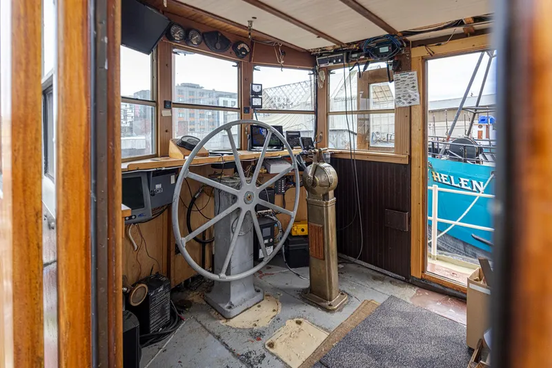Slide: The Image of 1943 Custom Navy Tug wheelhouse with vintage steering wheel and navigational equipment. - 13