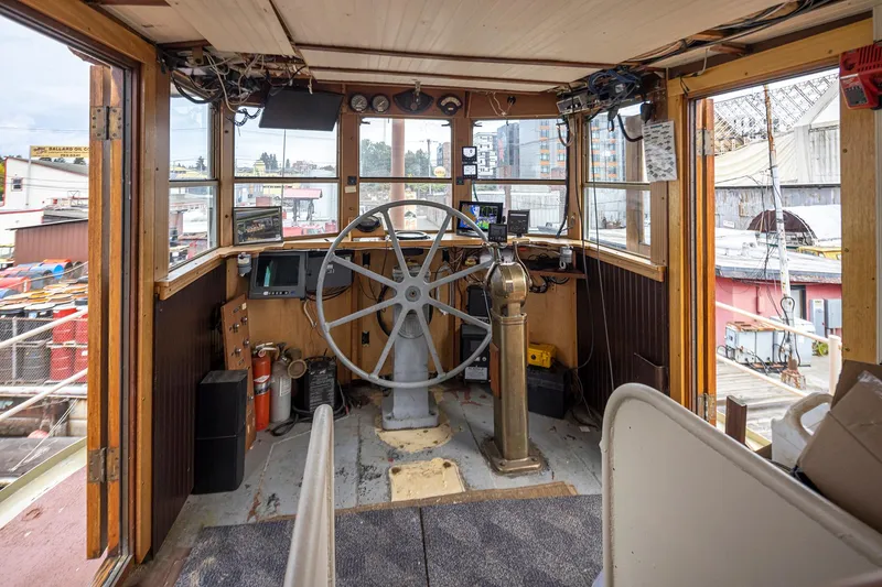 Slide: The Image of Interior of a 1943 Custom Navy Tugboat with vintage steering wheel and navigation equipment. - 14