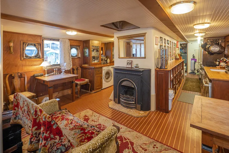 Slide: The Image of Interior of a 1943 Custom Navy Tug, featuring cozy wood decor and vintage furnishings. - 21