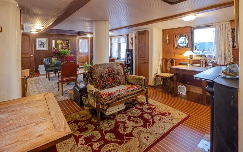 Slide: The Image of Interior of a 1943 Custom Navy Tug, featuring vintage decor and wooden furnishings. - 22