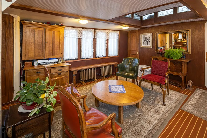 Slide: The Image of Interior of a 1943 Custom Navy Tug with vintage furniture and wooden decor. - 25