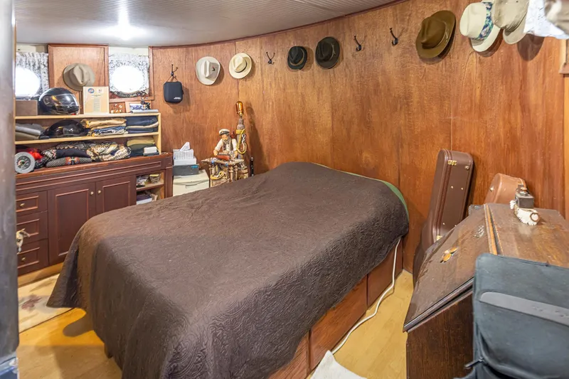 Slide: The Image of Cozy cabin interior of 1943 Custom Navy Tug with hats and wooden furnishings. - 45