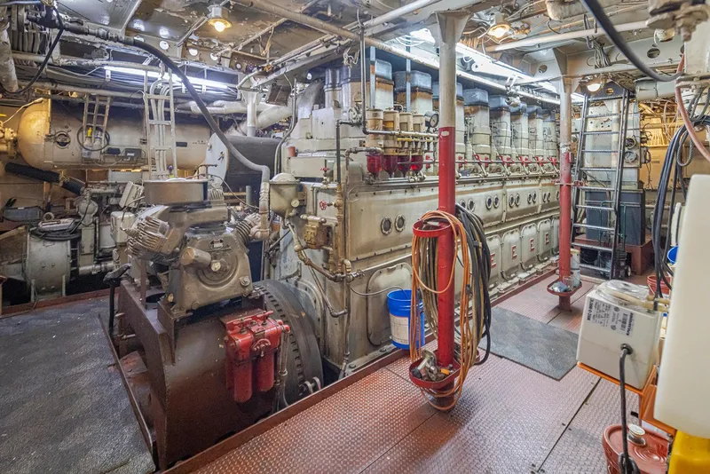 Slide: The Image of Engine room of a 1943 Custom Navy Tug, showcasing vintage machinery and equipment. - 47