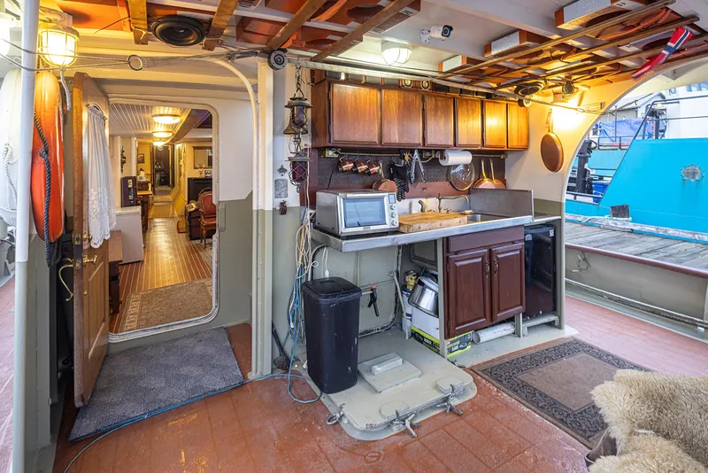 Slide: The Image of Interior of a 1943 Custom Navy Tug with kitchen and cozy living area. - 5