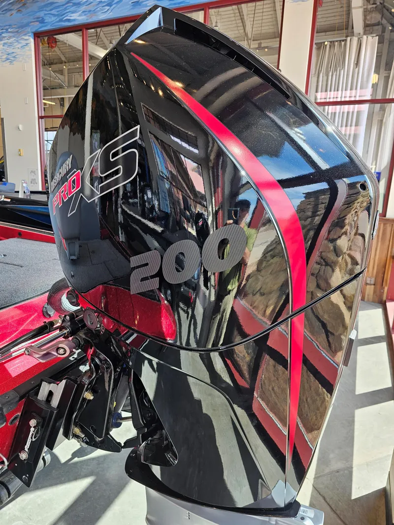 Slide: The Image of 2023 Triton 18 TrX boat with a powerful 200 Pro XS engine, sleek black and red design. - 2