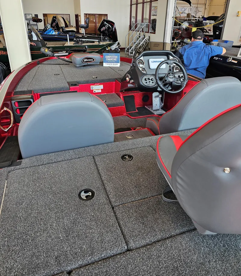 Slide: The Image of 2023 Triton 18 TrX boat interior with steering console and seating. - 3