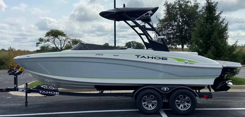Slide: The Image of 2023 Tahoe 210 Si Limited boat on a trailer in a parking lot. - 3