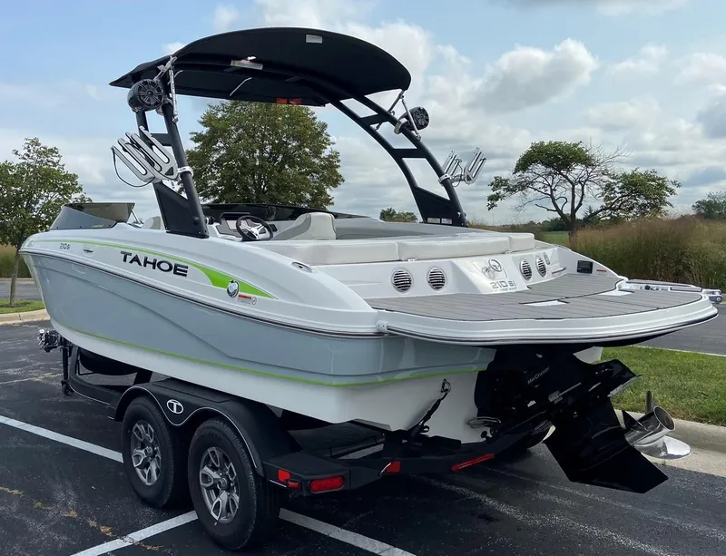 Slide: The Image of 2023 Tahoe 210 Si Limited boat on trailer in parking lot. - 4
