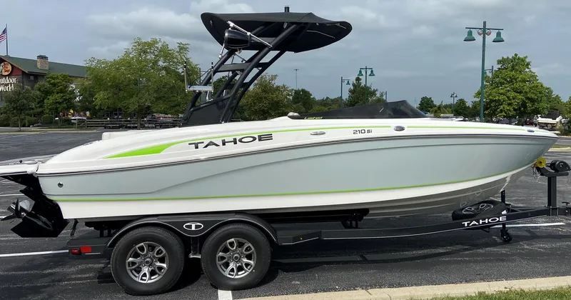 Slide: The Image of 2023 Tahoe 210 Si Limited boat on a trailer in a parking lot. - 6