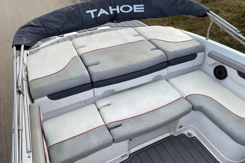 Slide: The Image of 2023 Tahoe 210 Si boat interior with cushioned seating and sleek design. - 12