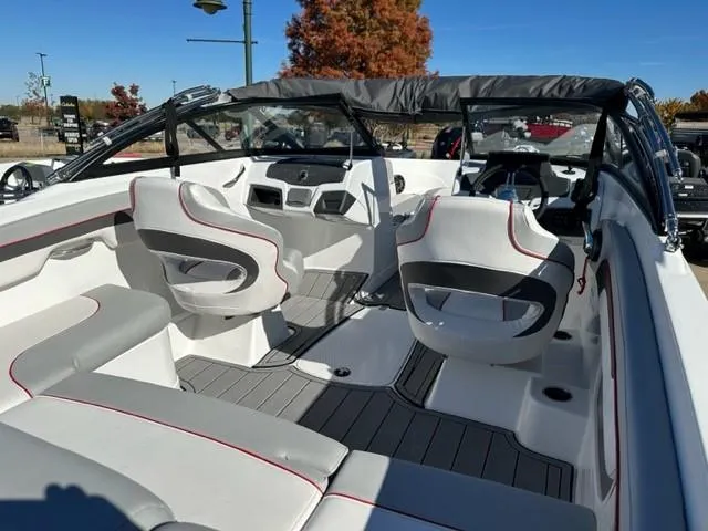 Slide: The Image of 2023 Tahoe 210 Si boat on trailer under cloudy sky. - 3