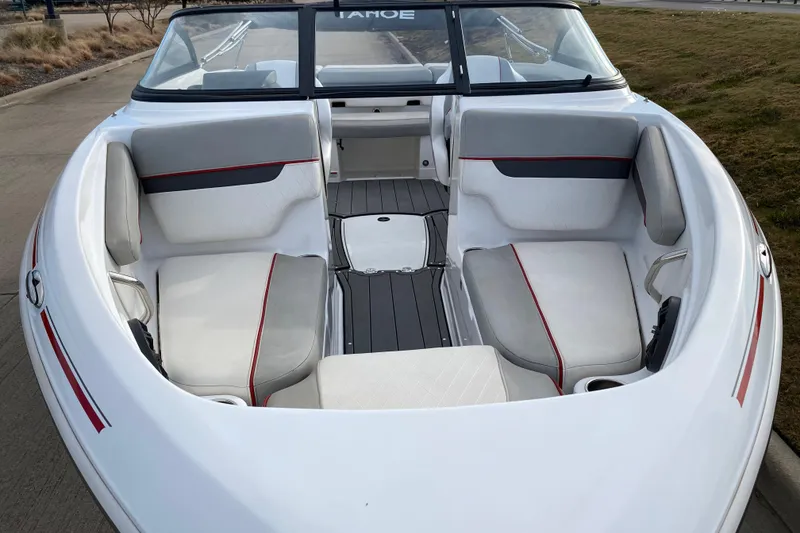 Slide: The Image of 2023 Tahoe 210 Si boat interior with white and gray seating, red accents. - 5