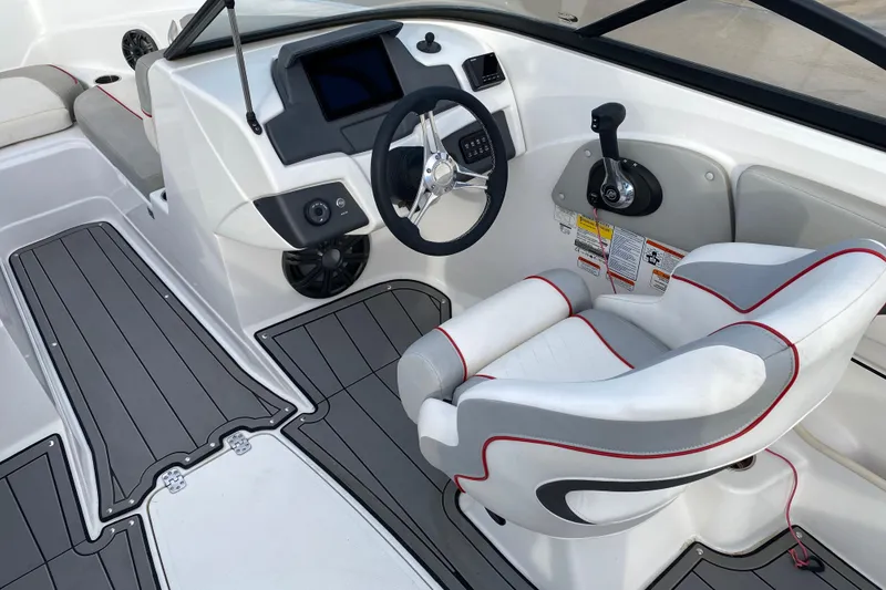 Slide: The Image of 2023 Tahoe 210 Si boat interior with steering wheel and captain's chair. - 8