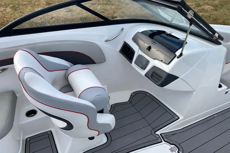 Slide: The Image of 2023 Tahoe 210 Si boat interior with sleek white and gray seating, modern dashboard. - 9