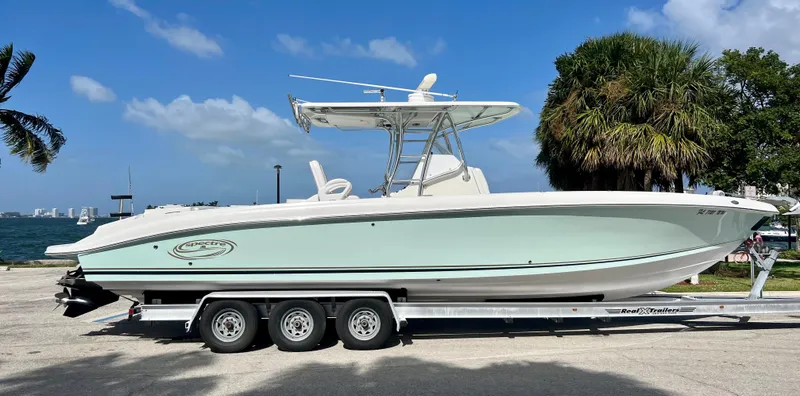 Slide: The Image of 2009 Spectre Sportfish boat on a trailer, parked near the waterfront. - 0