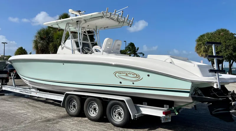 Slide: The Image of 2009 Spectre Sportfish boat on a trailer under a clear blue sky. - 10