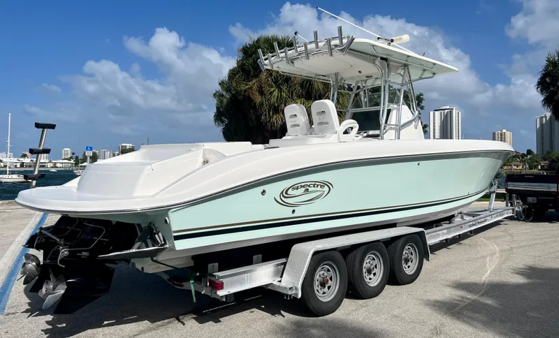 Slide: The Image of 2009 Spectre Sportfish boat on a triple-axle trailer at a marina. - 11