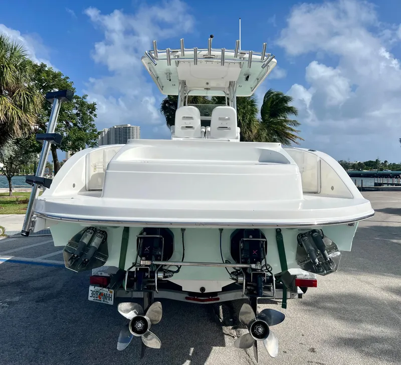 Slide: The Image of 2009 Spectre Sportfish boat with dual outboard motors, parked on a sunny day. - 12
