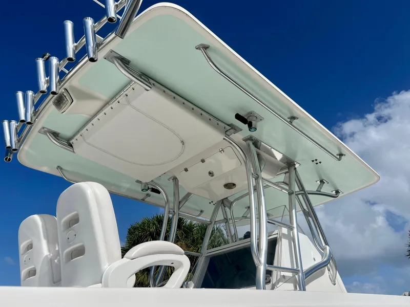 Slide: The Image of 2009 Spectre Sportfish boat with T-top and rod holders against blue sky. - 14