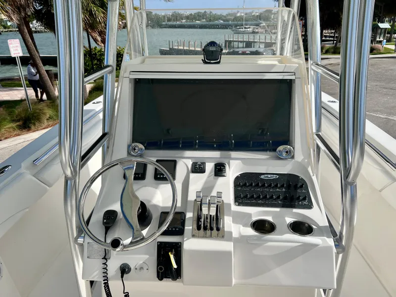Slide: The Image of 2009 Spectre Sportfish boat console with steering wheel, controls, and electronics. - 16