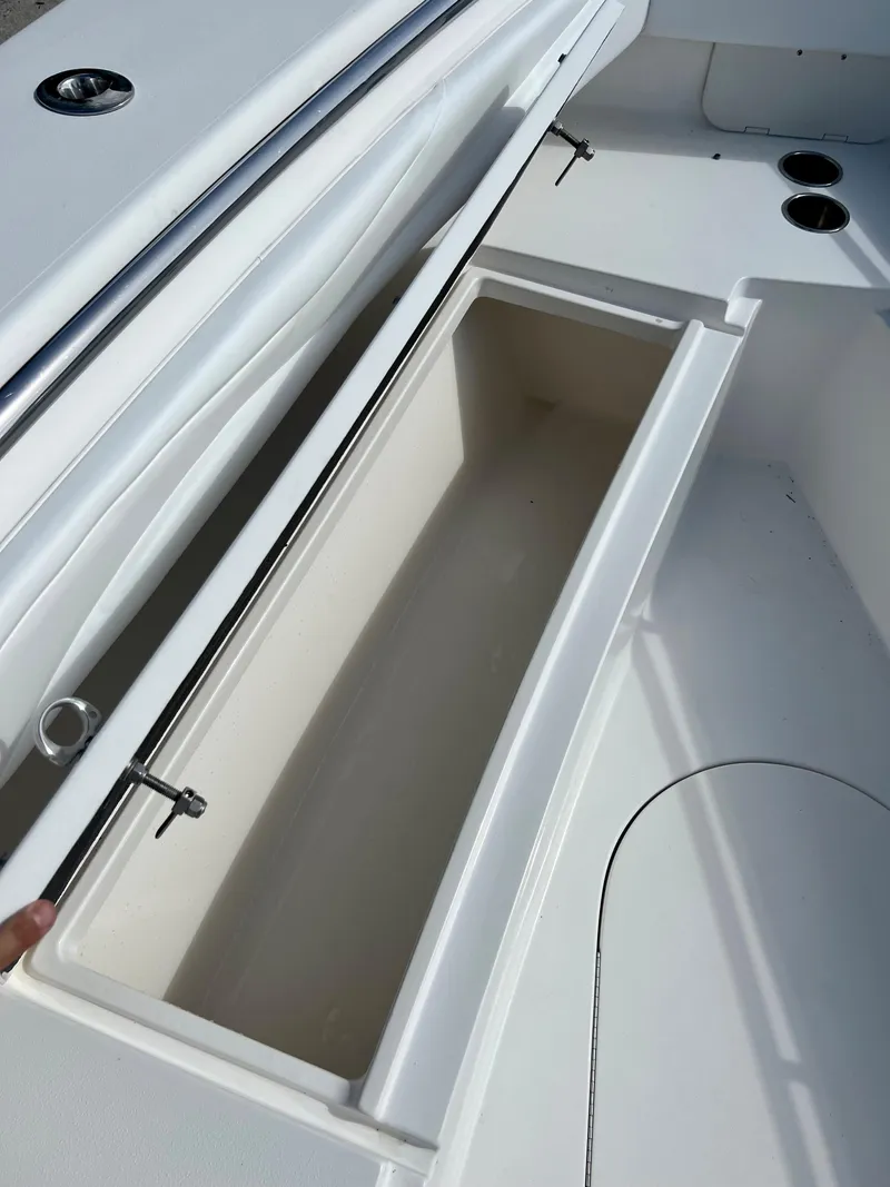 Slide: The Image of Open storage compartment on a 2009 Spectre Sportfish boat. - 18