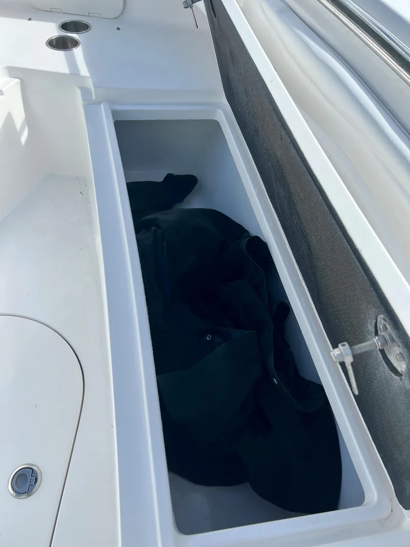 Slide: The Image of Storage compartment on a 2009 Spectre Sportfish boat with black fabric inside. - 19