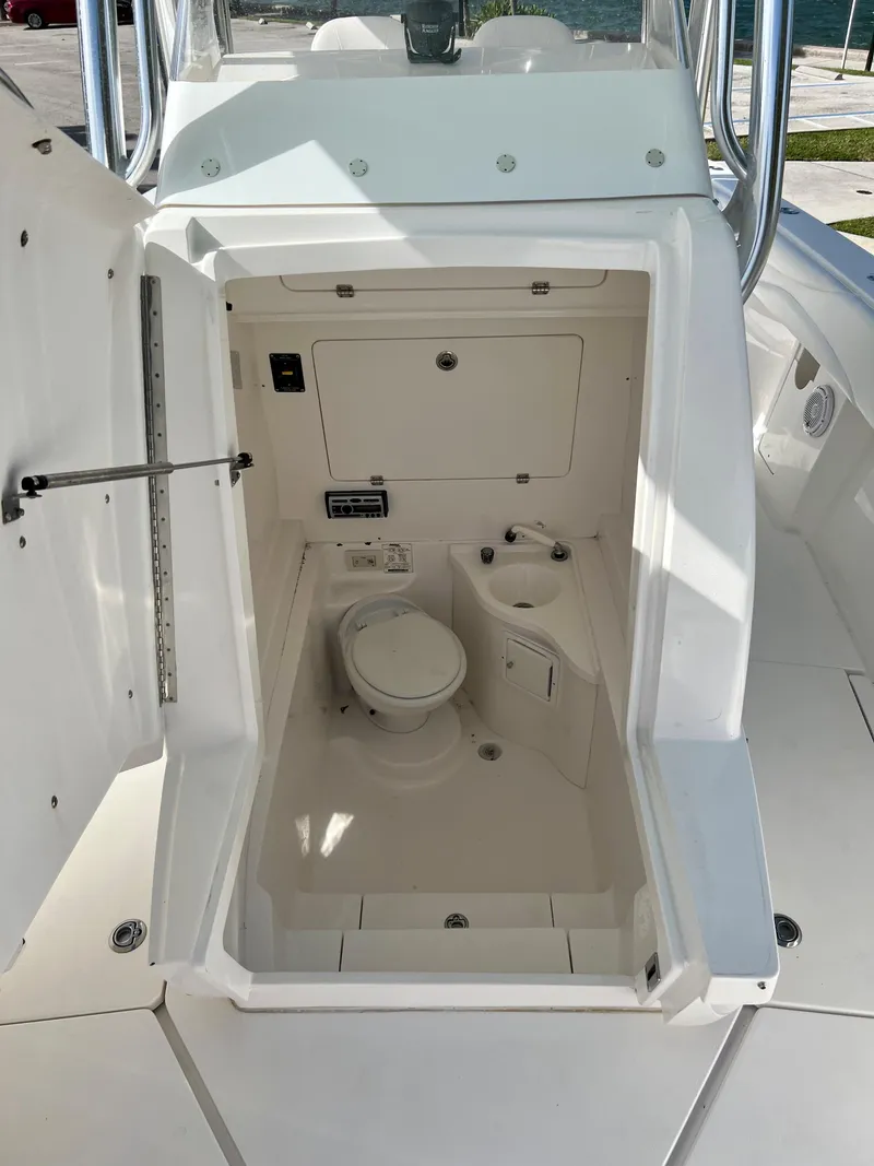 Slide: The Image of 2009 Spectre Sportfish boat interior with a compact marine toilet. - 29