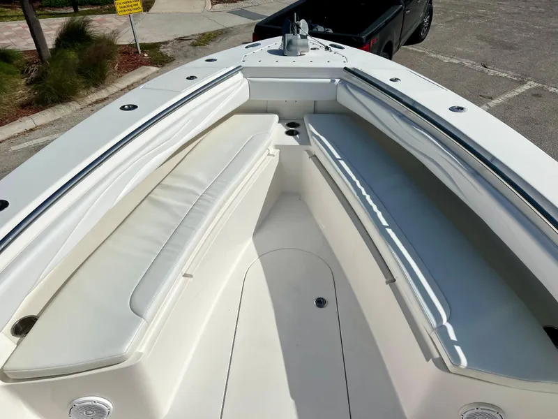Slide: The Image of 2009 Spectre Sportfish boat with white cushioned seating in the bow area. - 30