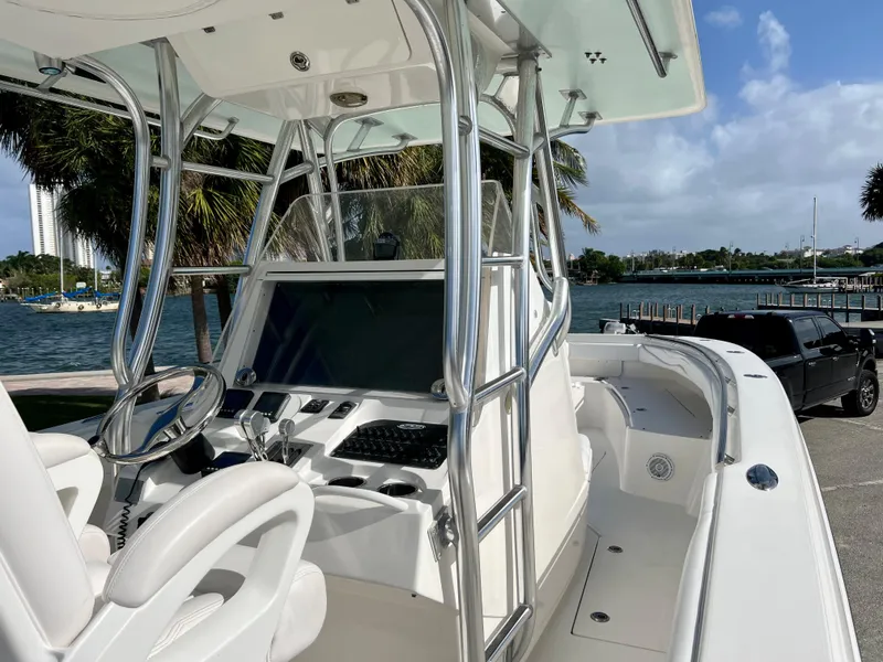 Slide: The Image of 2009 Spectre Sportfish boat with modern console and steering wheel docked by the waterfront. - 31
