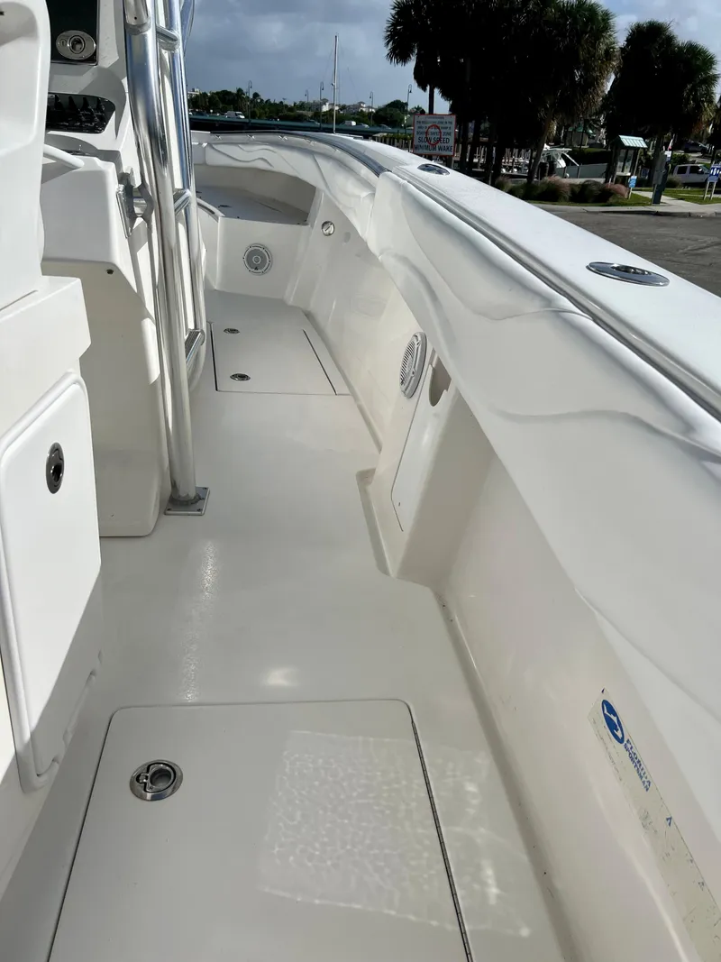 Slide: The Image of 2009 Spectre Sportfish boat deck with storage compartments and clean white finish. - 32