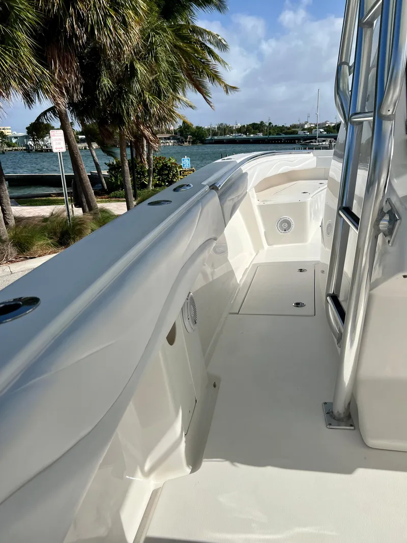 Slide: The Image of 2009 Spectre Sportfish boat docked near palm trees and waterfront. - 33