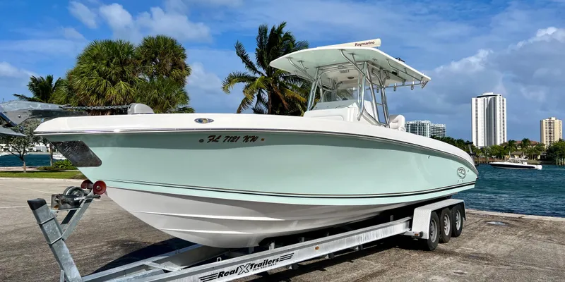 Slide: The Image of 2009 Spectre Sportfish boat on a trailer by the waterfront. - 7