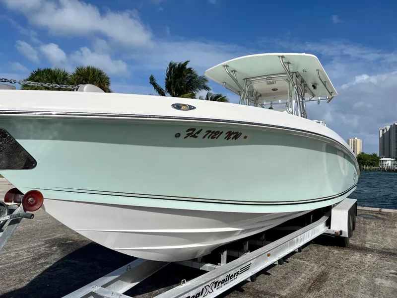 Slide: The Image of 2009 Spectre Sportfish boat on trailer by the water. - 8
